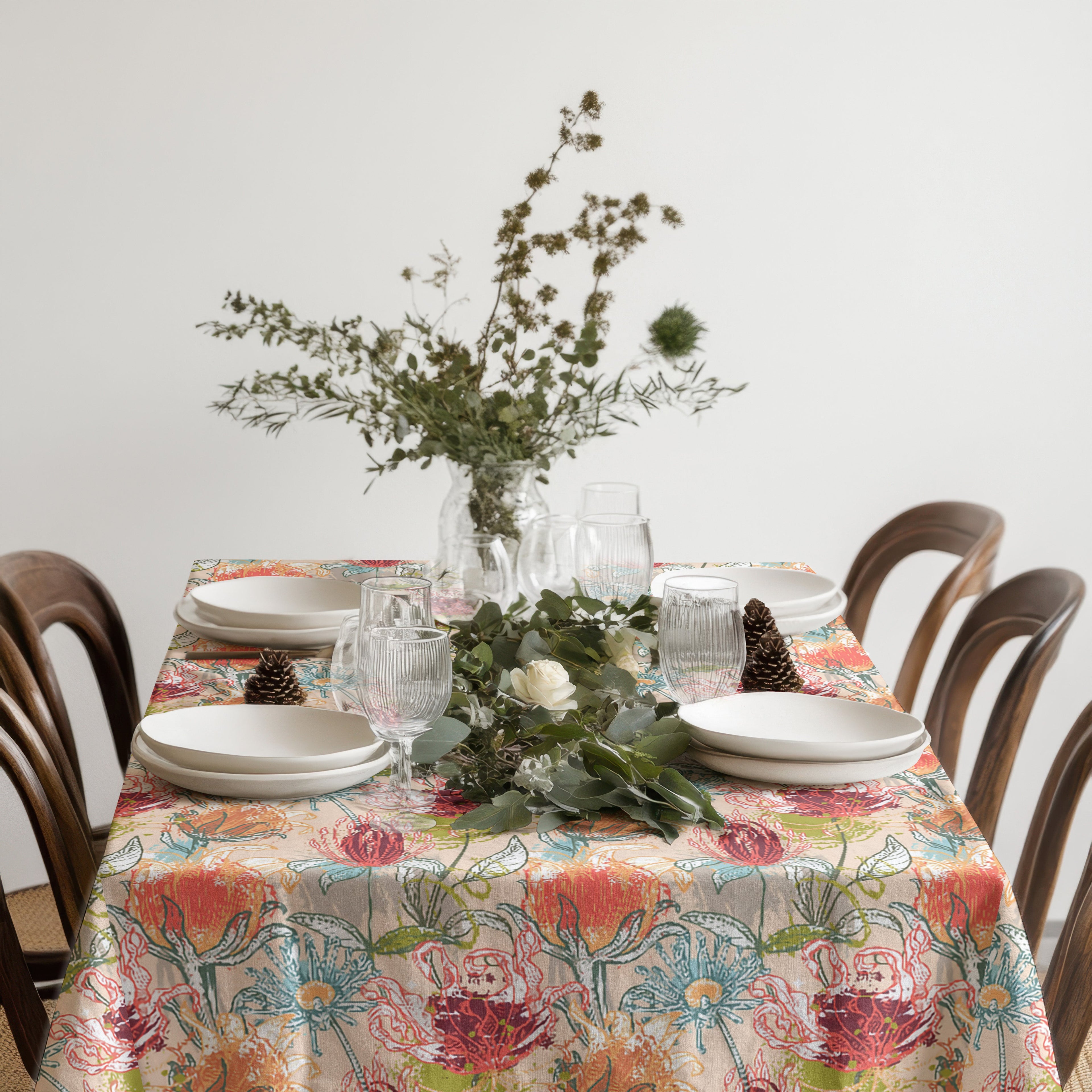Mediterranean botanical tablecloth styled with colourful home decor and a fresh table linen colour palette.