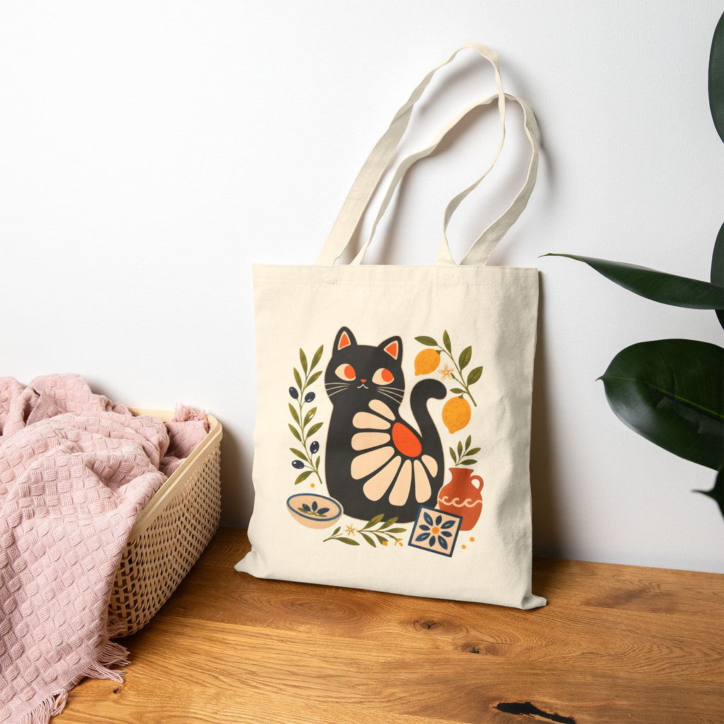 Double-sided cotton tote bag featuring a whimsical black cat surrounded by Mediterranean-inspired botanical elements.