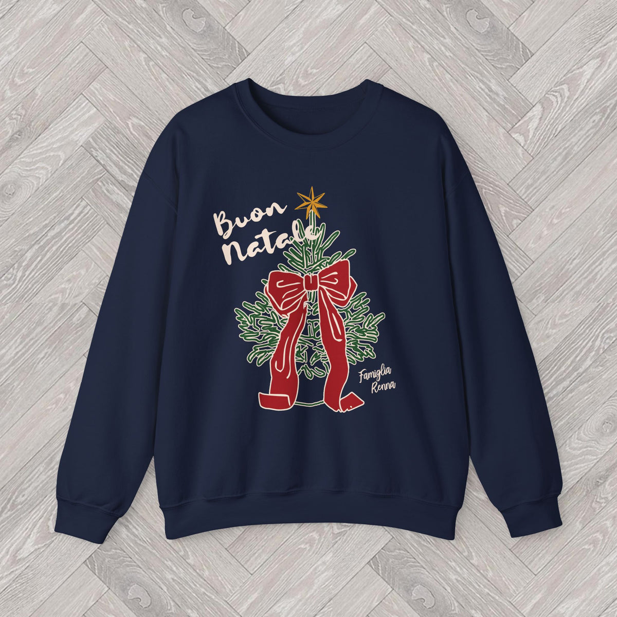 Close-up of the DTG-printed Buon Natale sweatshirt artwork showing the Christmas tree, decorative red bow and golden star.