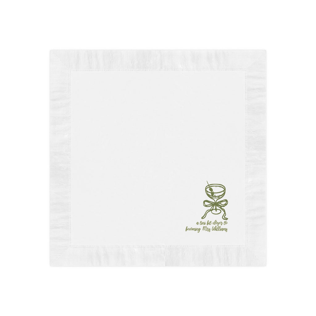 Close-up of a premium white coined-edge martini theme napkin personalized with a custom name for a special event.