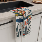 Decorative microfiber kitchen tea towel featuring hand-painted style wildflowers in warm Mediterranean colours on a cream background.