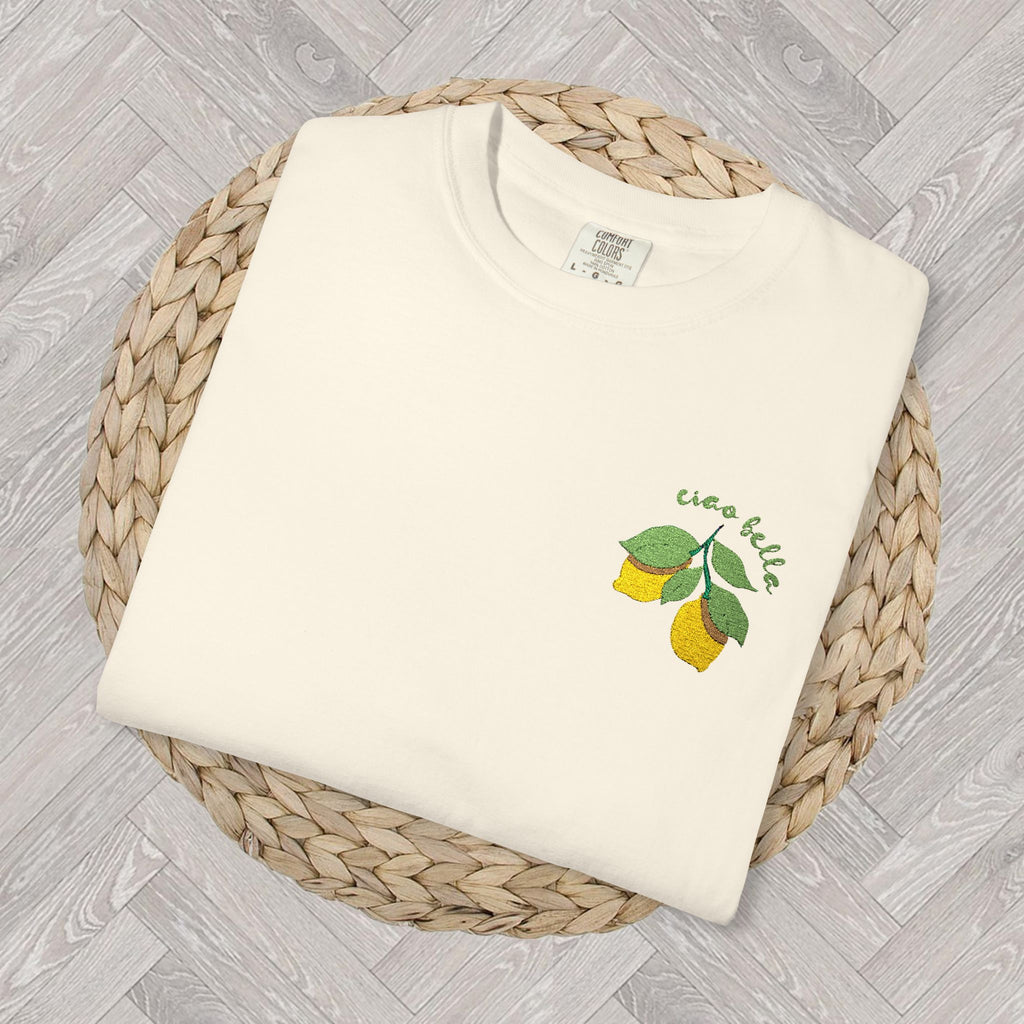 Playful and colorful embroidered lemon design on a high-quality shirt, ideal for summer style.