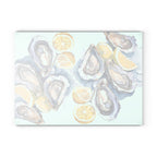 Back view of Coastal kitchen accessory with oyster shells, lemon slices and watercolor artwork glass cutting board