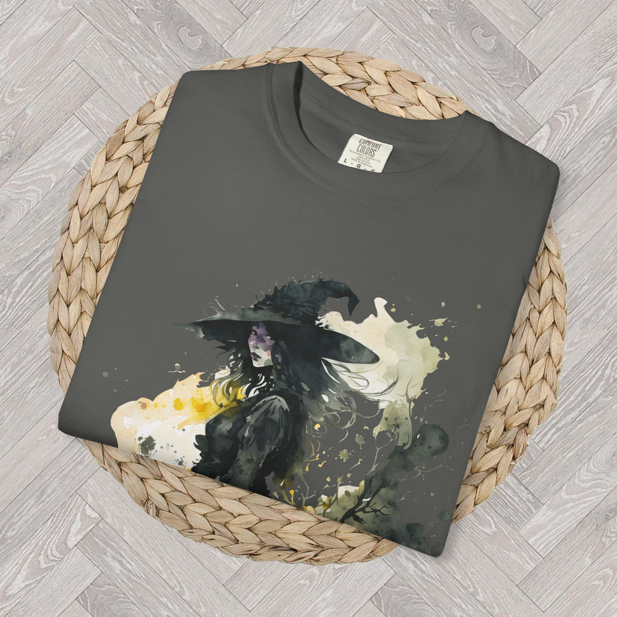 Close up view of watercolor witch graphic design featuring a witch hat, moonlight details, and magical Halloween artwork