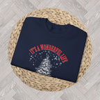 Close-up of cream vintage-style Christmas artwork featuring a decorated tree, martini glass, cocktail glass and snowflakes on a navy sweatshirt.