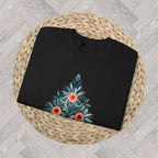 Close up Black Christmas crewneck featuring a Mediterranean-inspired folk-art Christmas tree.