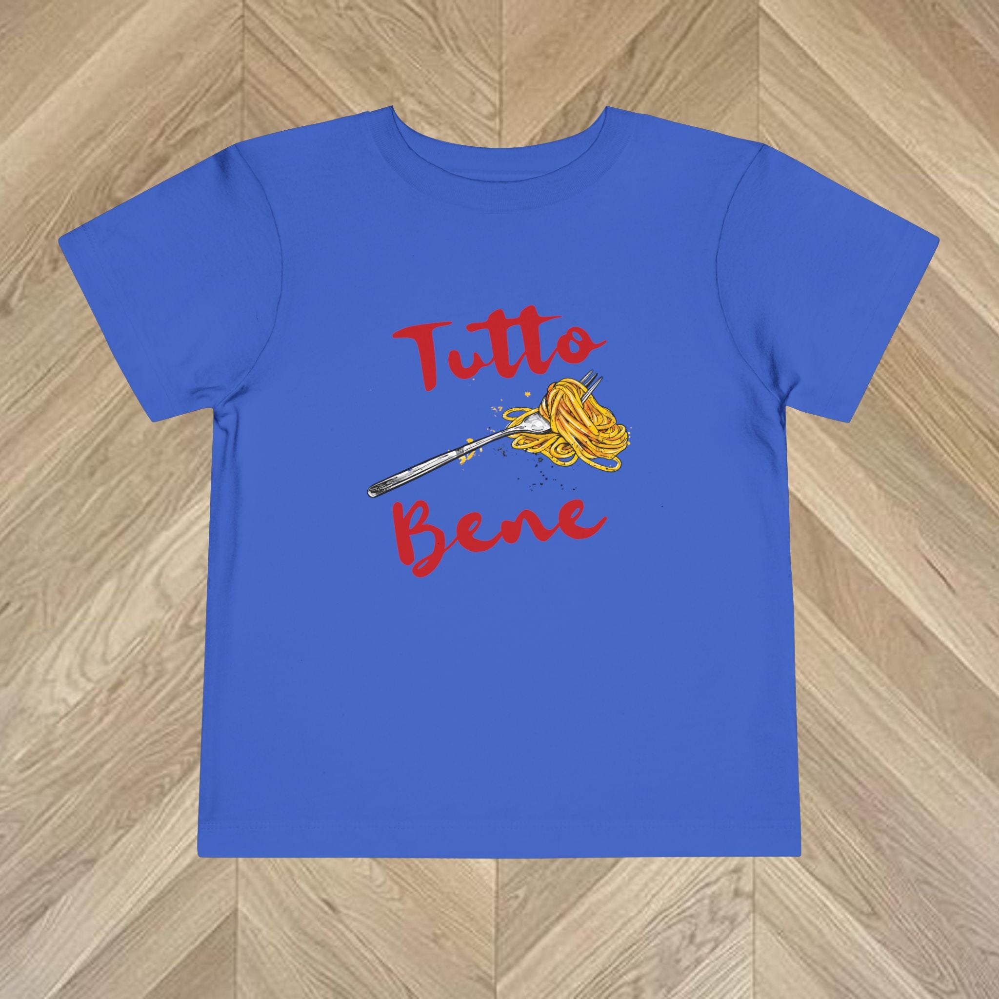 Bright royal blue kids “Tutto Bene” pasta graphic t-shirt with spaghetti fork artwork and bold red Italian text, playful Italy inspired kids tee.
