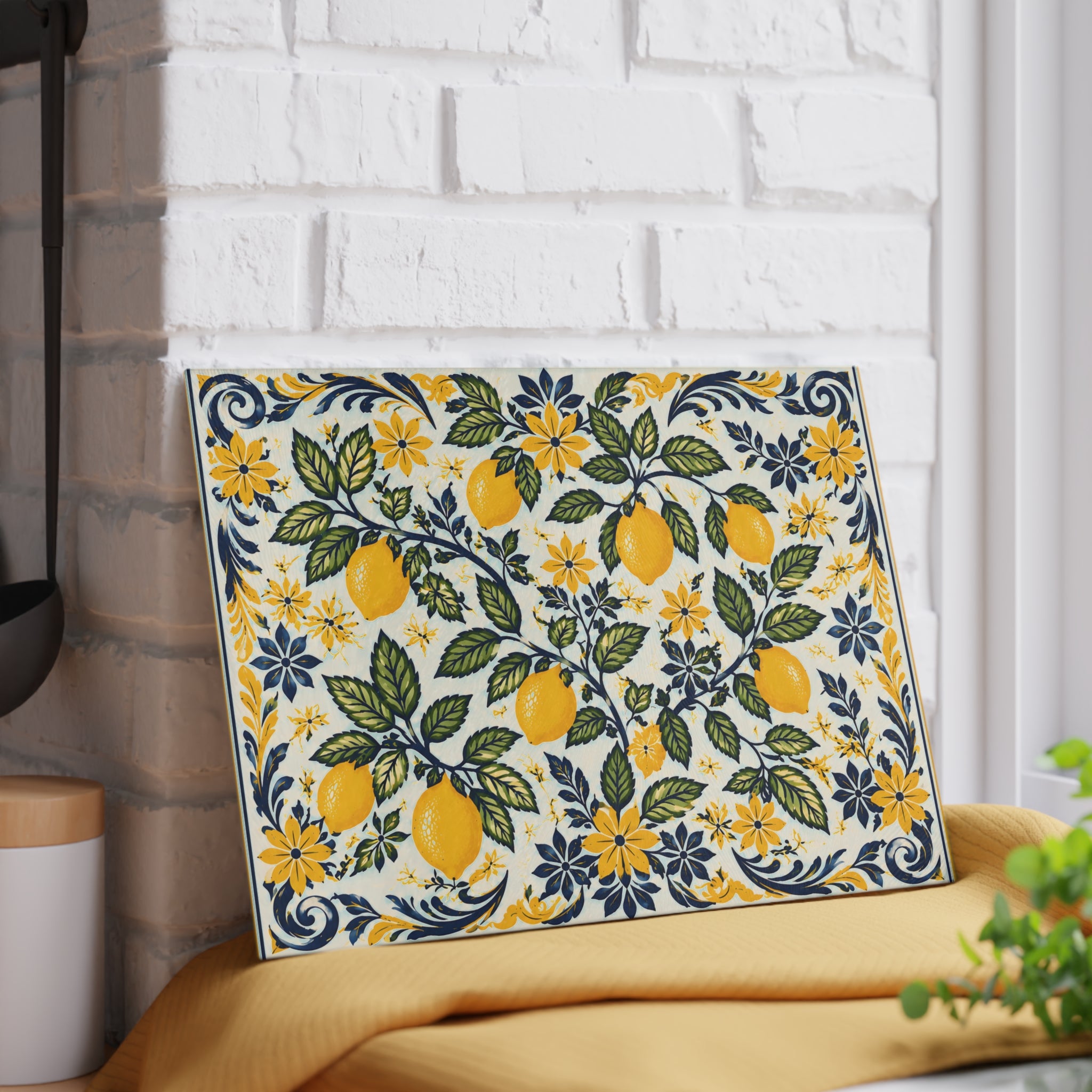 Decorative lemon cutting board with Mediterranean botanical artwork on a textured glass surface