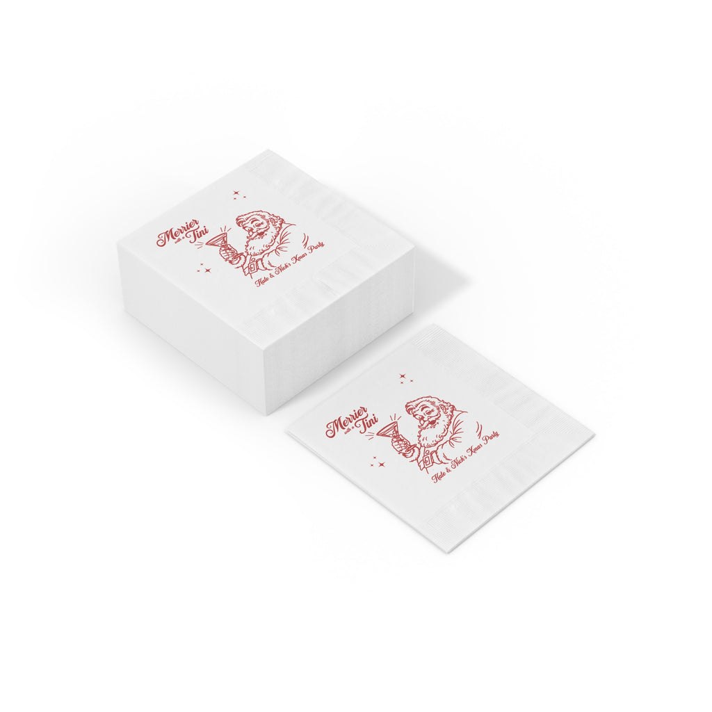 Smooth white three-ply paper texture of a Merrier with a Tini Christmas cocktail napkin with festive red printed artwork.