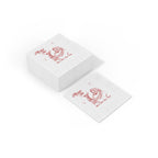 Smooth white three-ply paper texture of a Merrier with a Tini Christmas cocktail napkin with festive red printed artwork.