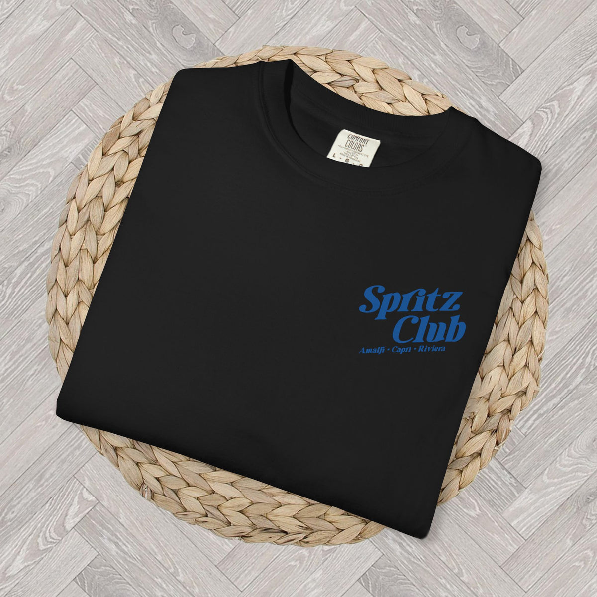 Folded Comfort Colors Spritz Club T-shirt showing the small front left-chest graphic and heavyweight cotton texture