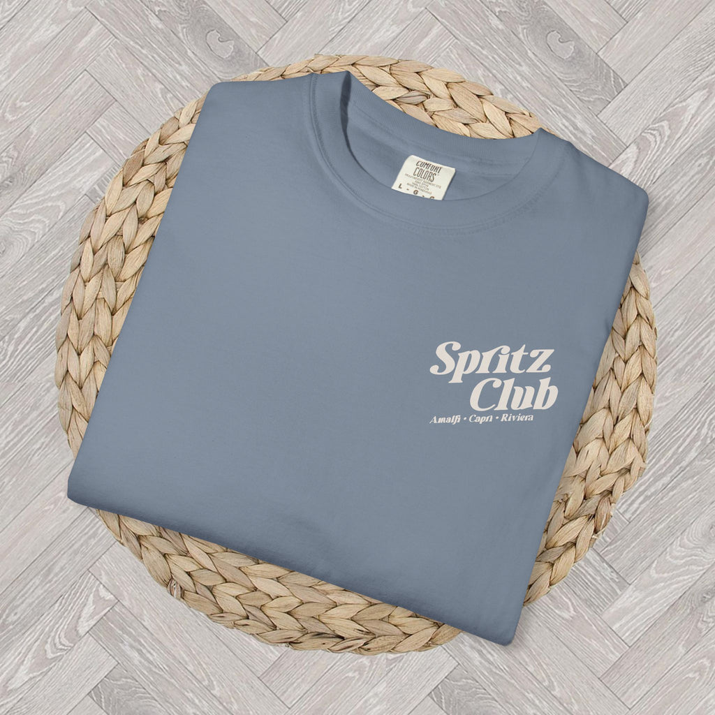 Folded Spritz Club heavyweight cotton tee with close-up view of the front left-corner chest text design