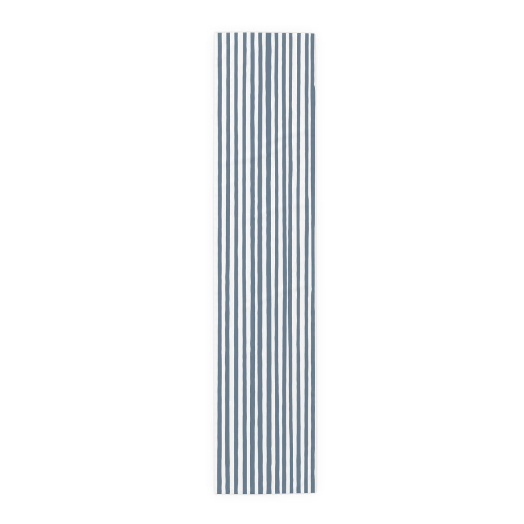 Modern coastal dining decor featuring a slate blue hand drawn stripe table runner and minimalist accessories