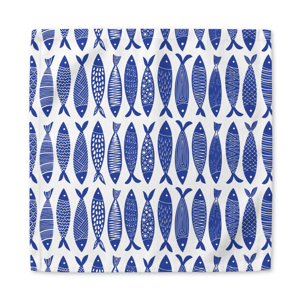 Coastal blue fish cloth napkins styled for beach house decor, seafood dinners, and elegant everyday table arrangements