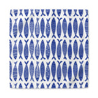 Coastal blue fish cloth napkins styled for beach house decor, seafood dinners, and elegant everyday table arrangements
