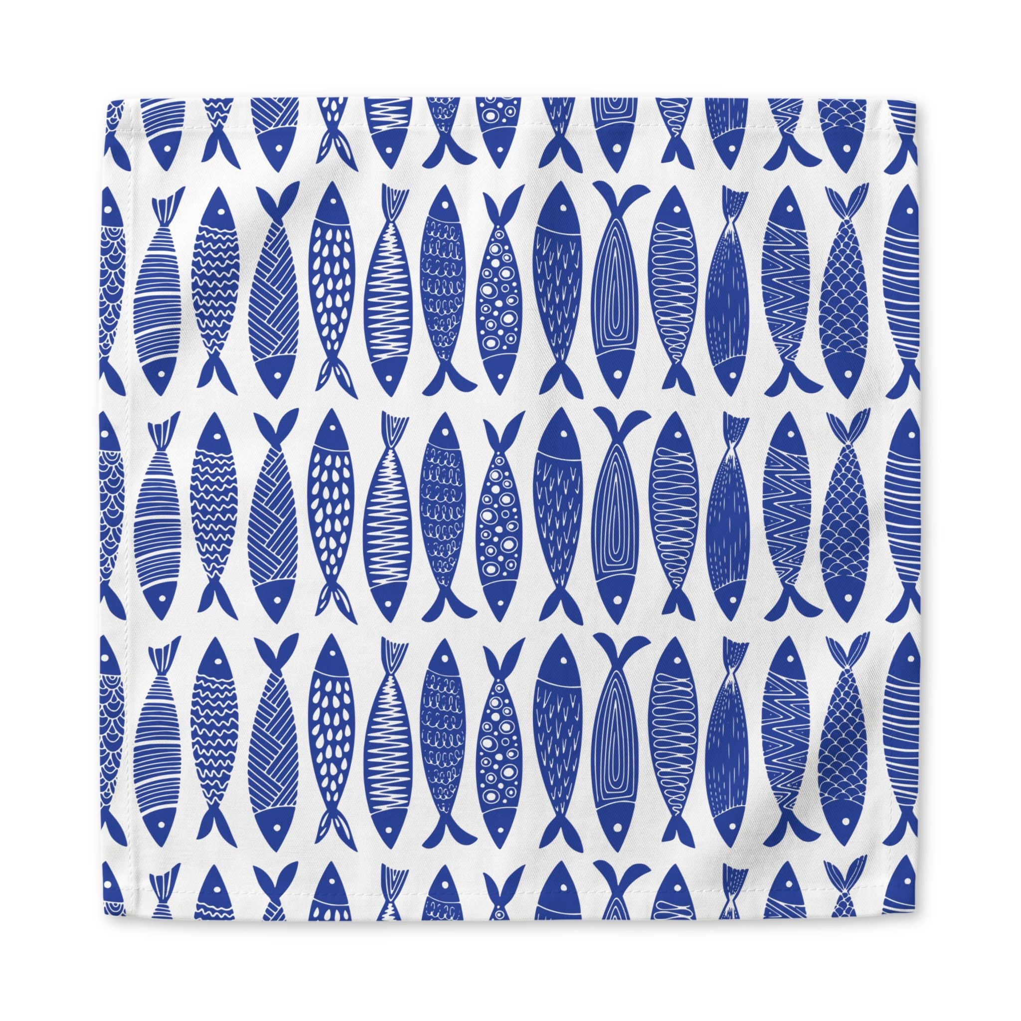 Coastal blue fish cloth napkins styled for beach house decor, seafood dinners, and elegant everyday table arrangements