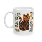 Artistic ceramic coffee mug with Mediterranean-inspired cat illustration and citrus botanical accents.