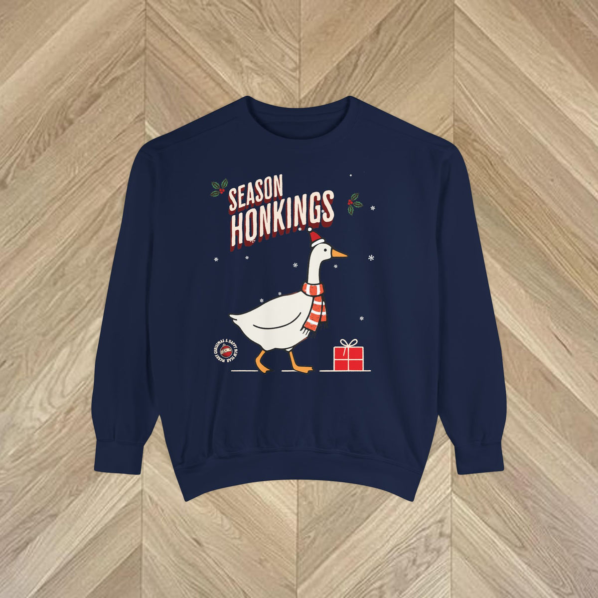 Close-up of the Season Honkings Christmas sweatshirt featuring a cheerful goose in a Santa hat, scarf and festive lettering.