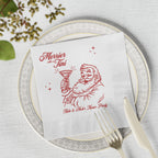 Merrier with a Tini personalised Christmas napkin styled for a festive cocktail party table with seasonal holiday decorations.