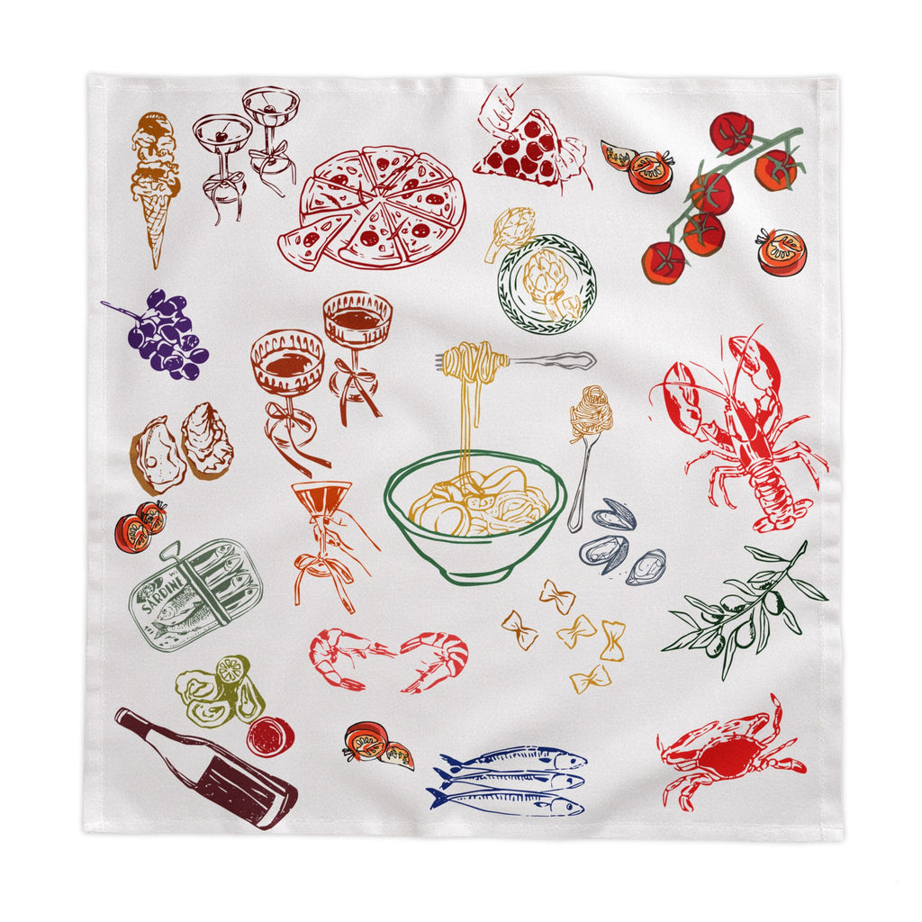 Modern Mediterranean home décor scene with a playful Italian summer tablecloth, natural textures, white ceramics and relaxed European dining atmosphere.