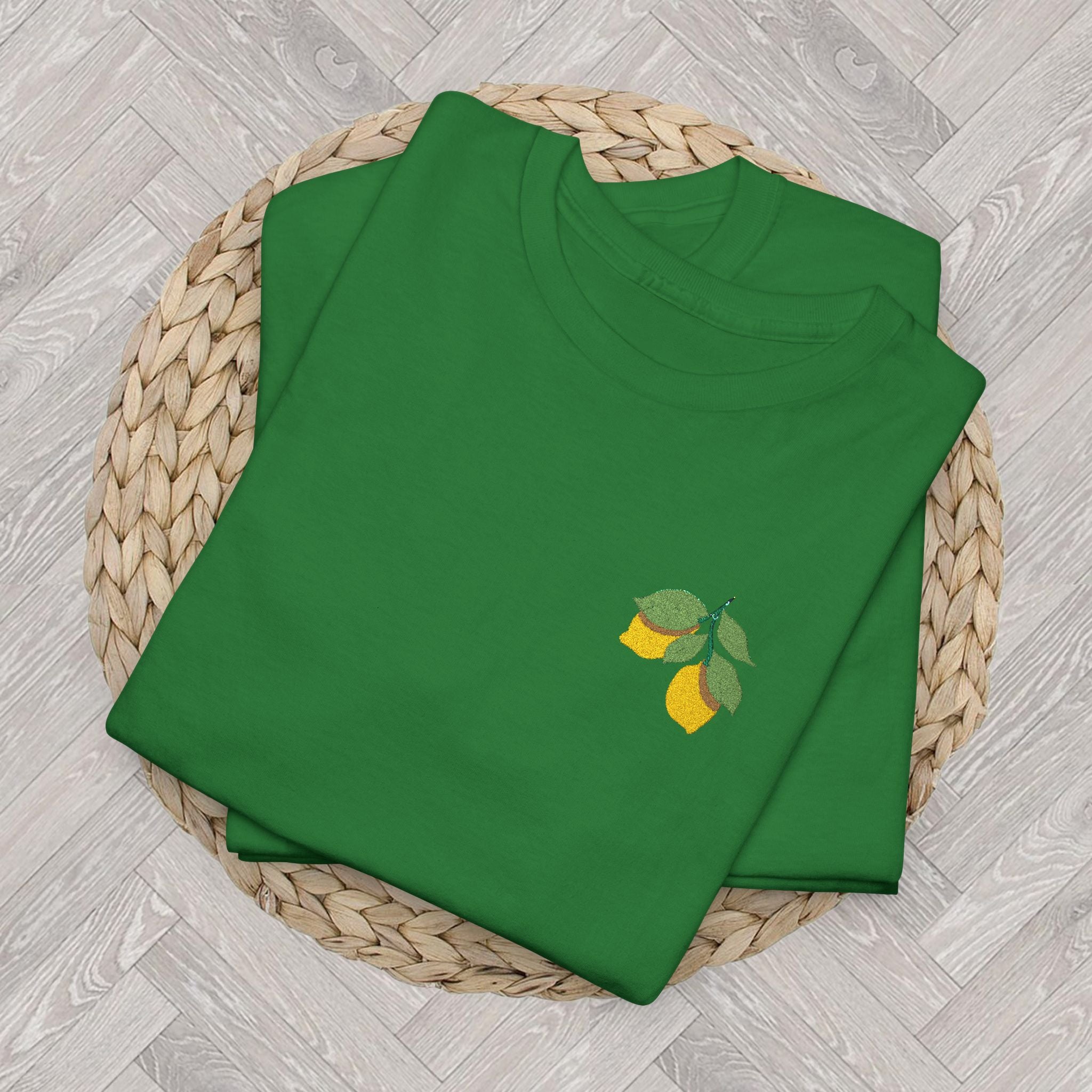 Folded Turf Green lemon embroidered tee highlighting the detailed citrus and green leaf embroidery