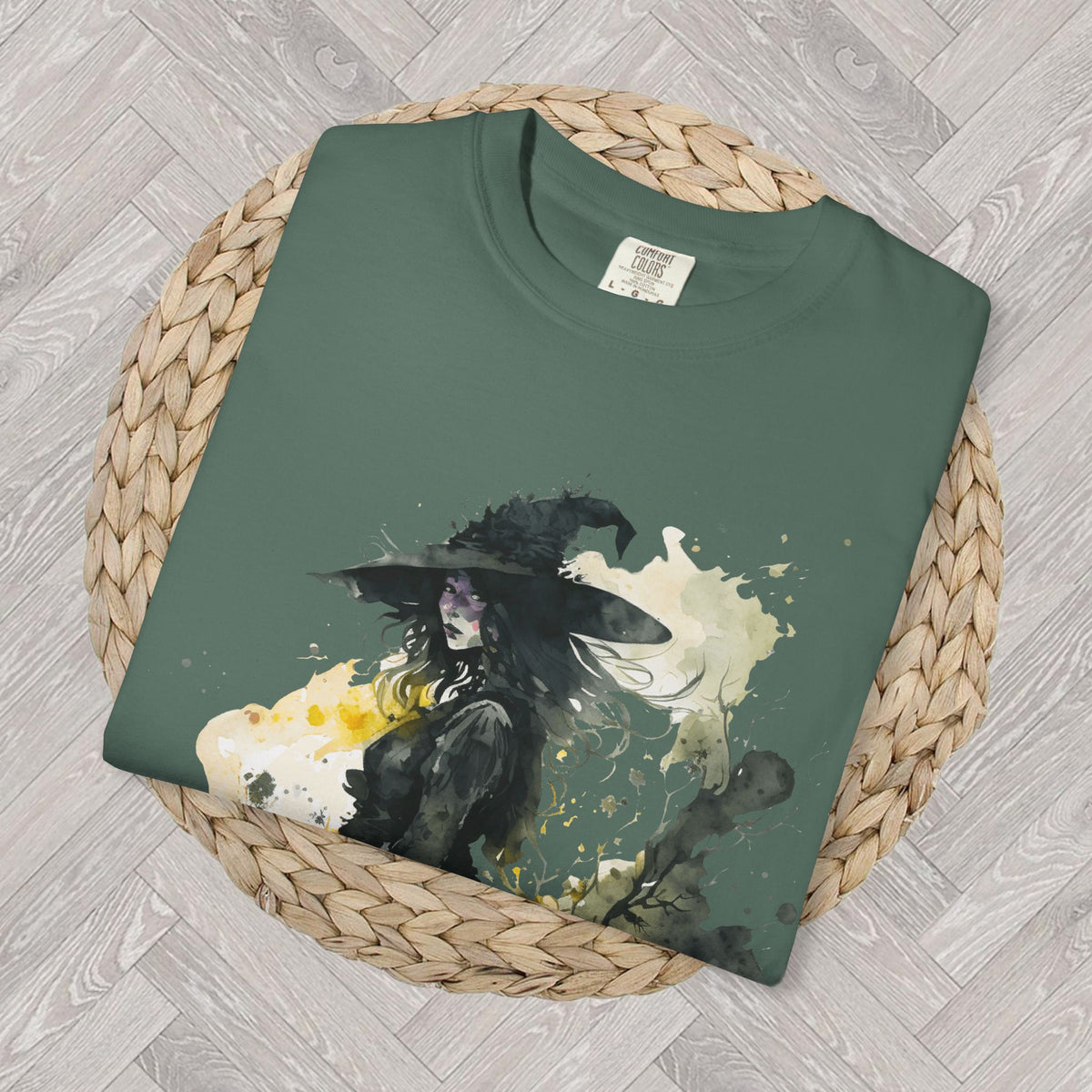 Detailed view of mystical watercolor Halloween print on Blue Spruce t-shirt featuring witch illustration and moon inspired design