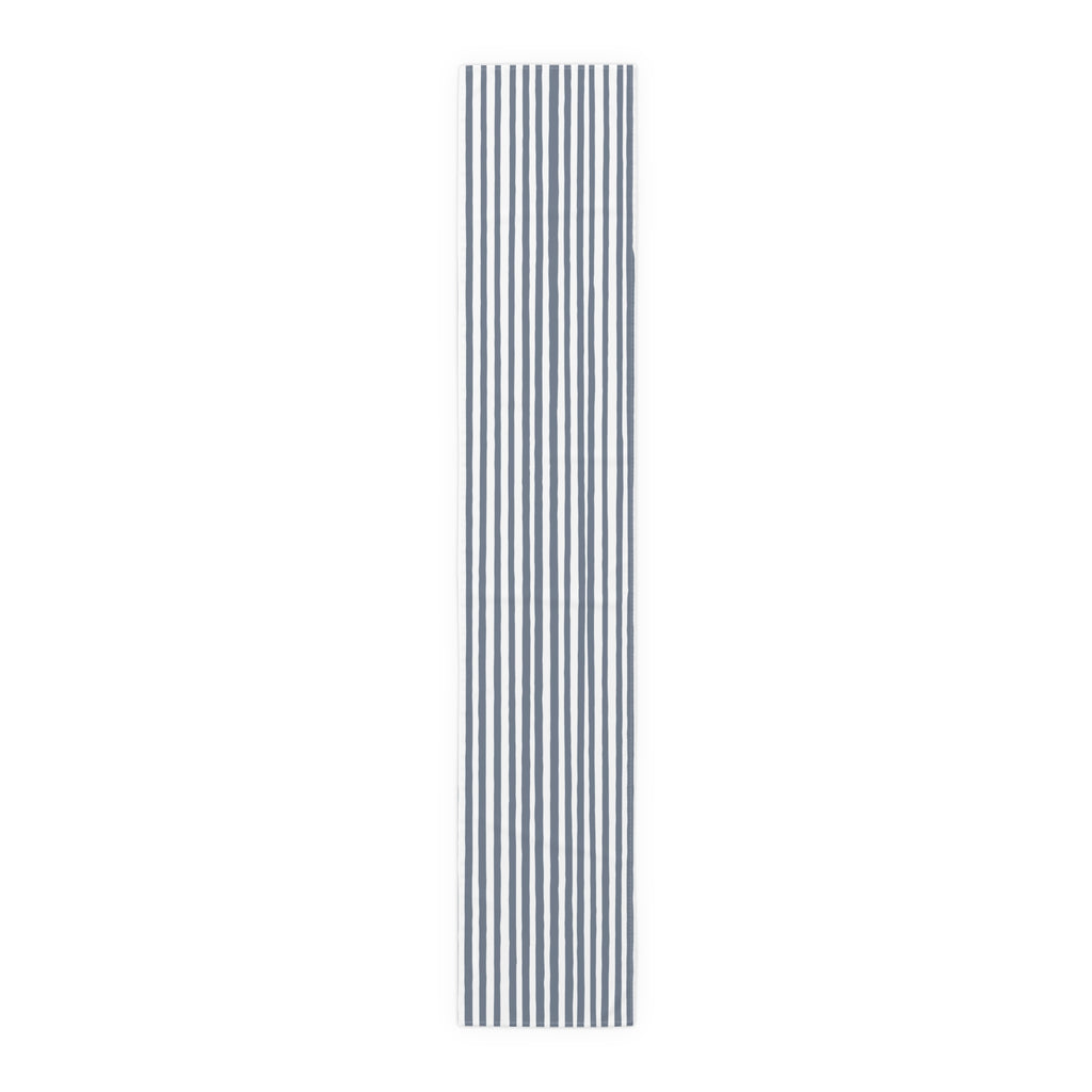 Modern dining table featuring a slate blue striped table runner.