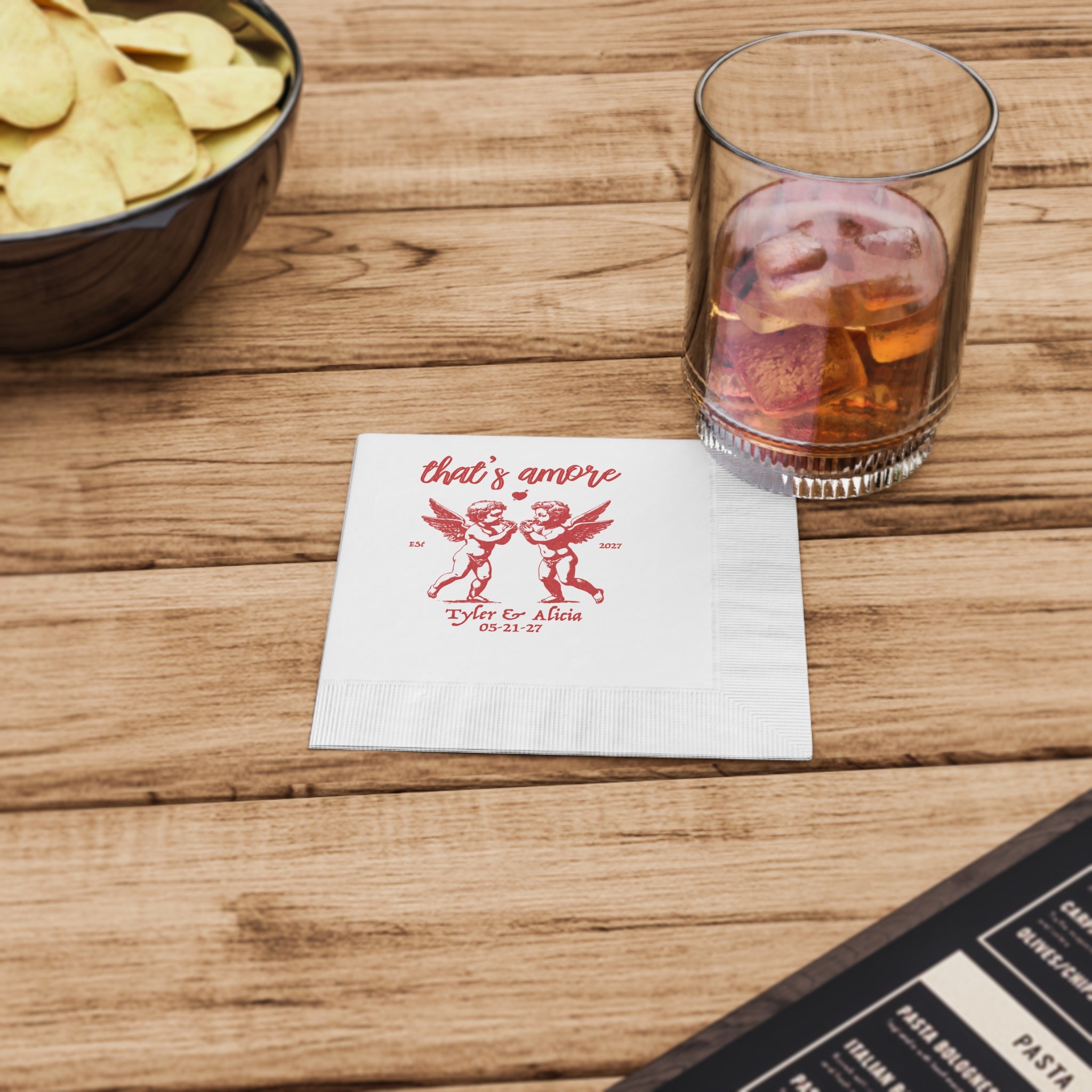 Custom luncheon napkins with That's Amore design, featuring personalized names and date for an Italian-inspired wedding.