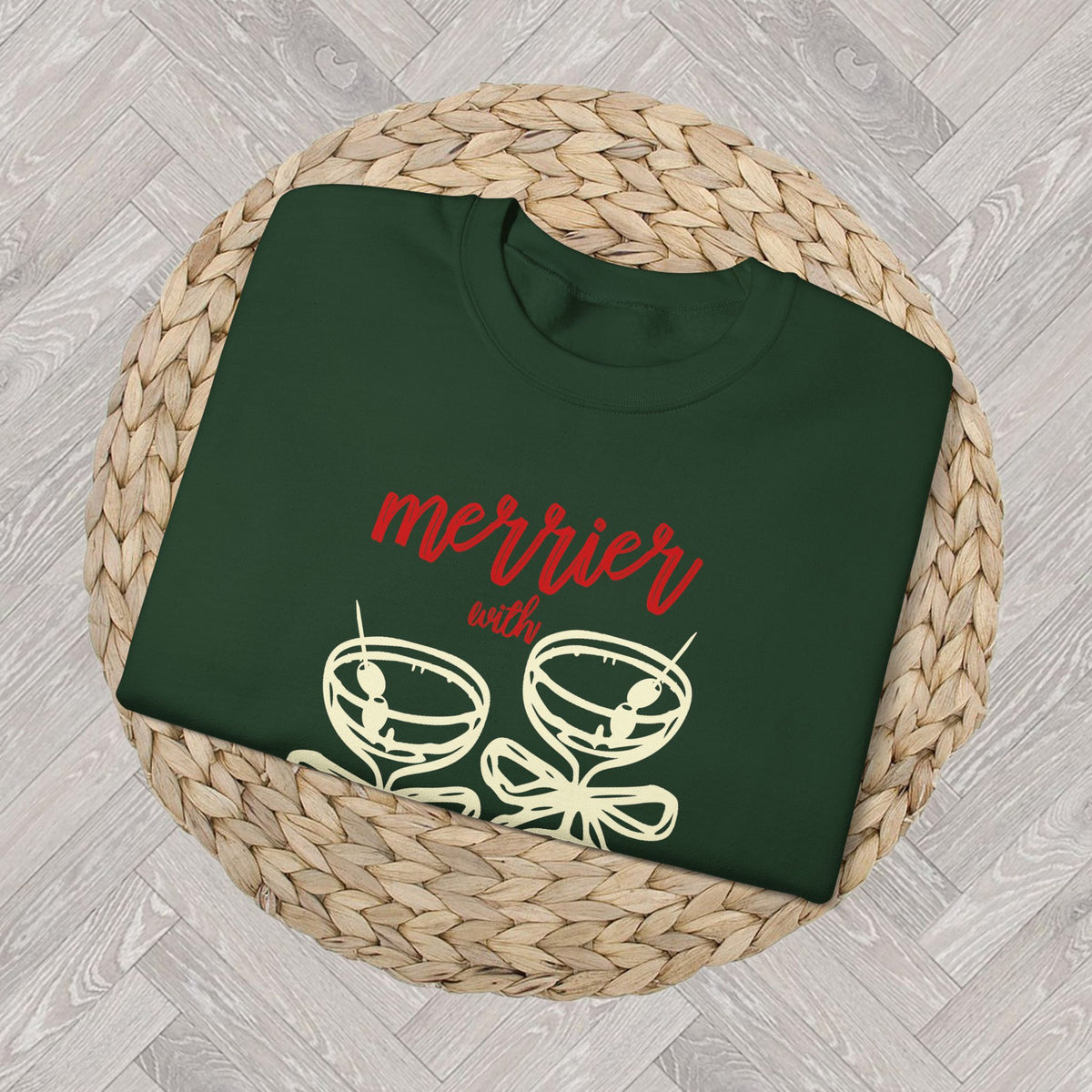 Close up Forest Green sweatshirt with the “Merrier with a Martini” Christmas cocktail graphic, neutral festive crewneck.