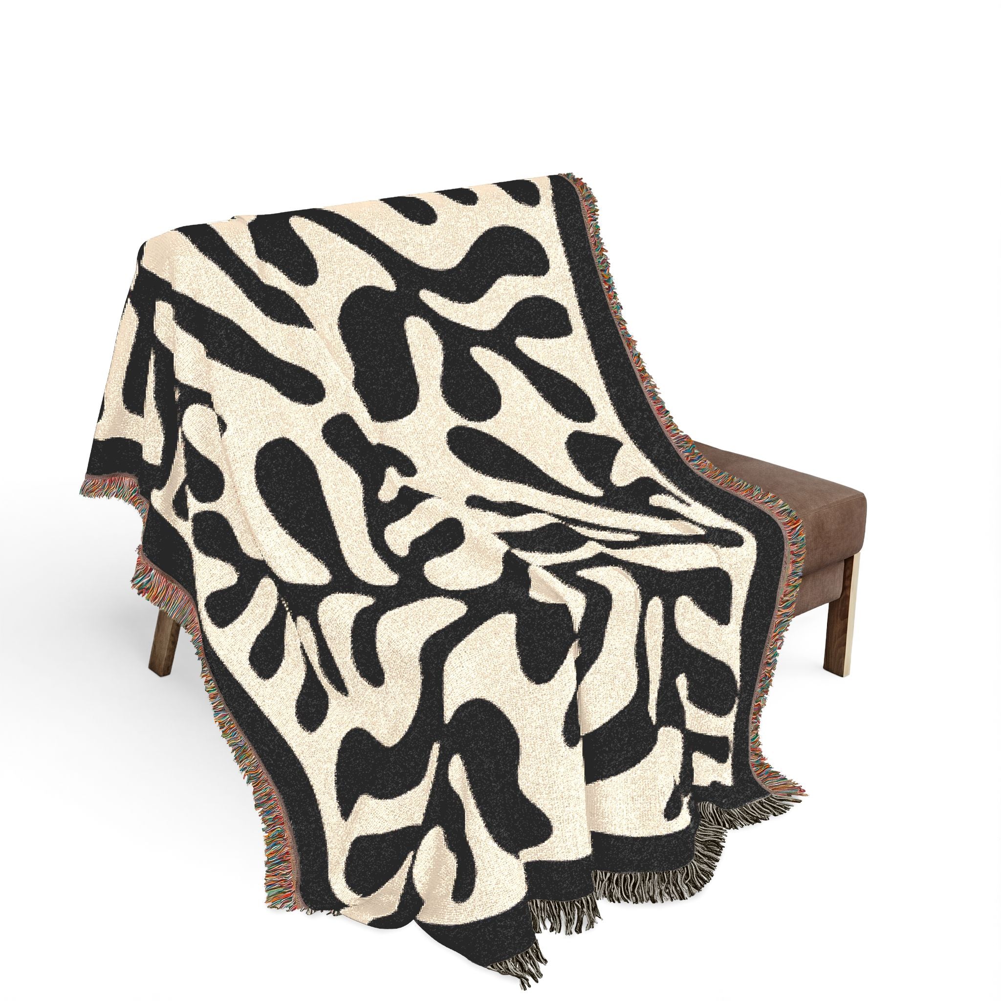 Black Matisse Pattern Woven Blanket hanging on a wall as a statement piece, blending modern art with functional decor.