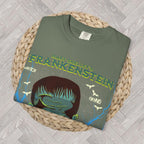 Moss: Moss green Frankenstein tee with vintage-inspired gothic monster graphic and dramatic lightning details