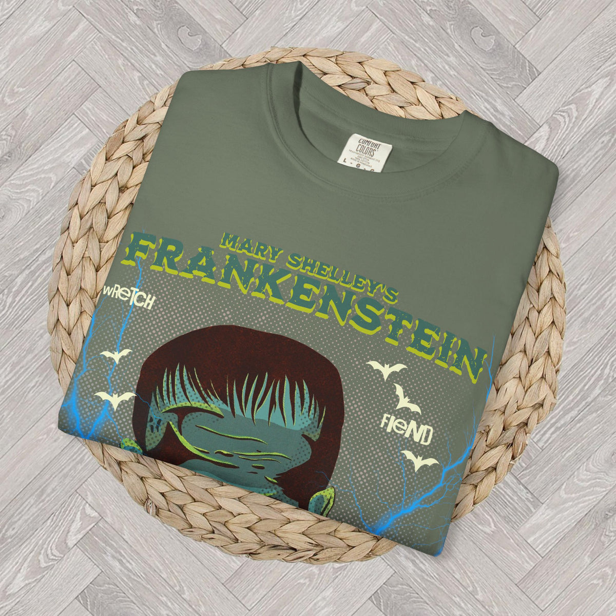 Moss: Moss green Frankenstein tee with vintage-inspired gothic monster graphic and dramatic lightning details