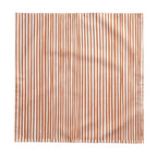 Soft terracotta and cream striped tablecloth paired with matching striped napkins and neutral ceramic tableware.