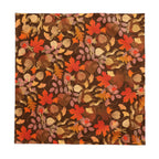 Warm autumn tablescape featuring cotton twill leaf tablecloth with candles, dishes, and seasonal accents