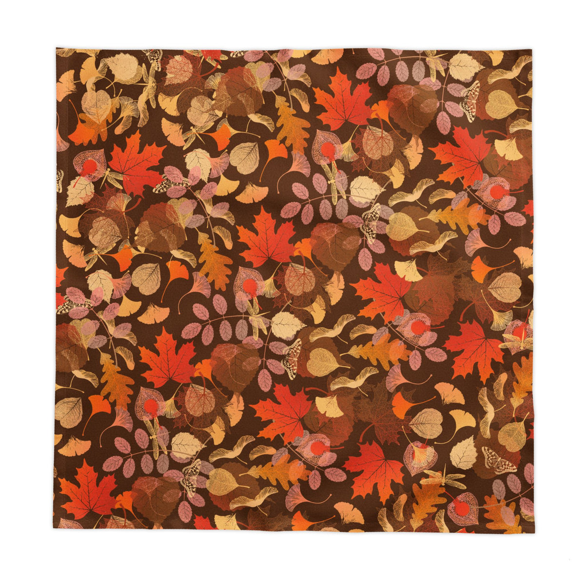 Warm autumn tablescape featuring cotton twill leaf tablecloth with candles, dishes, and seasonal accents
