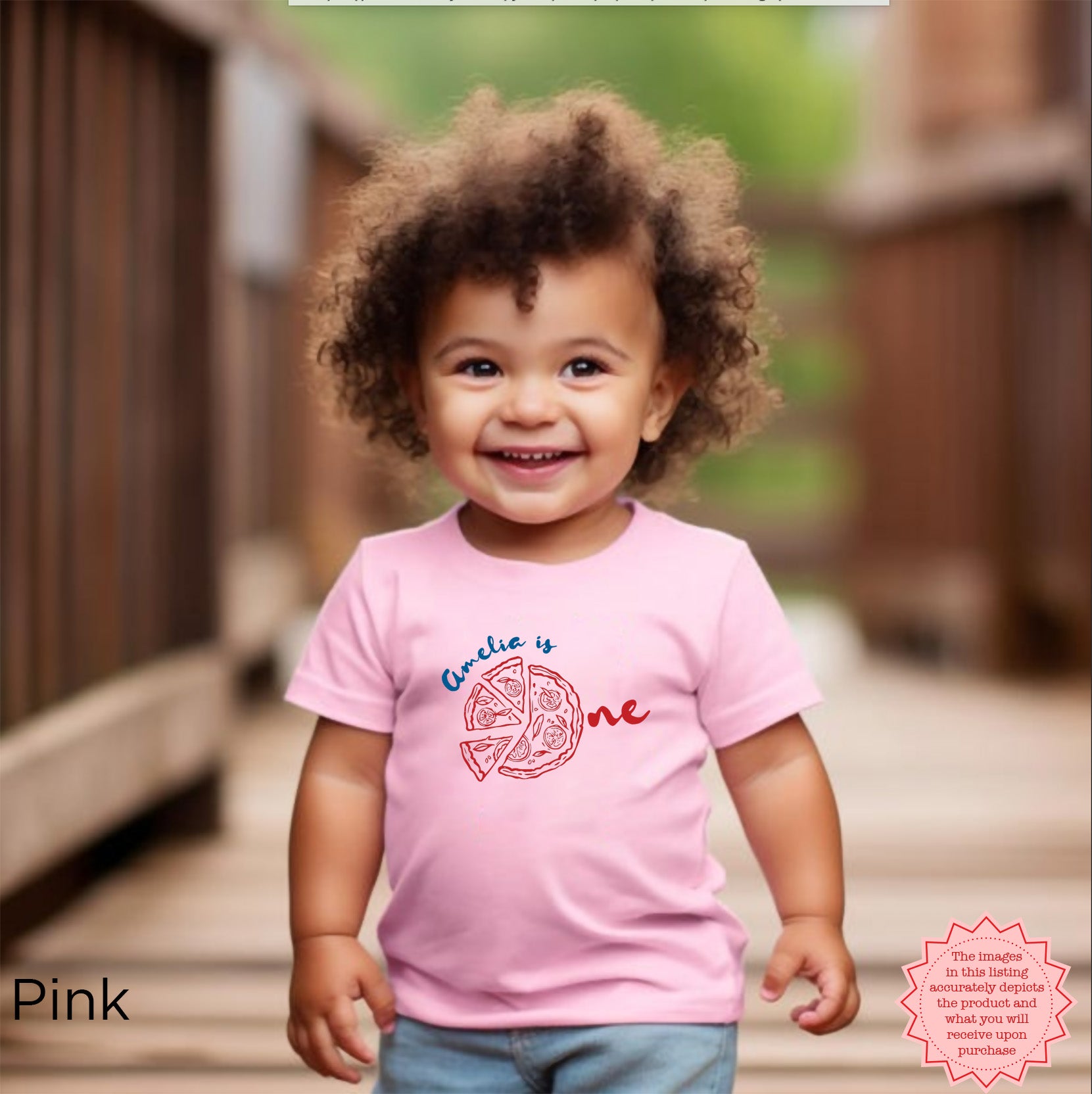 Curly-haired toddler wearing pink custom pizza birthday shirt with ‘Amelia is One’ graphic, personalized Italian-themed first birthday tee for girls.
