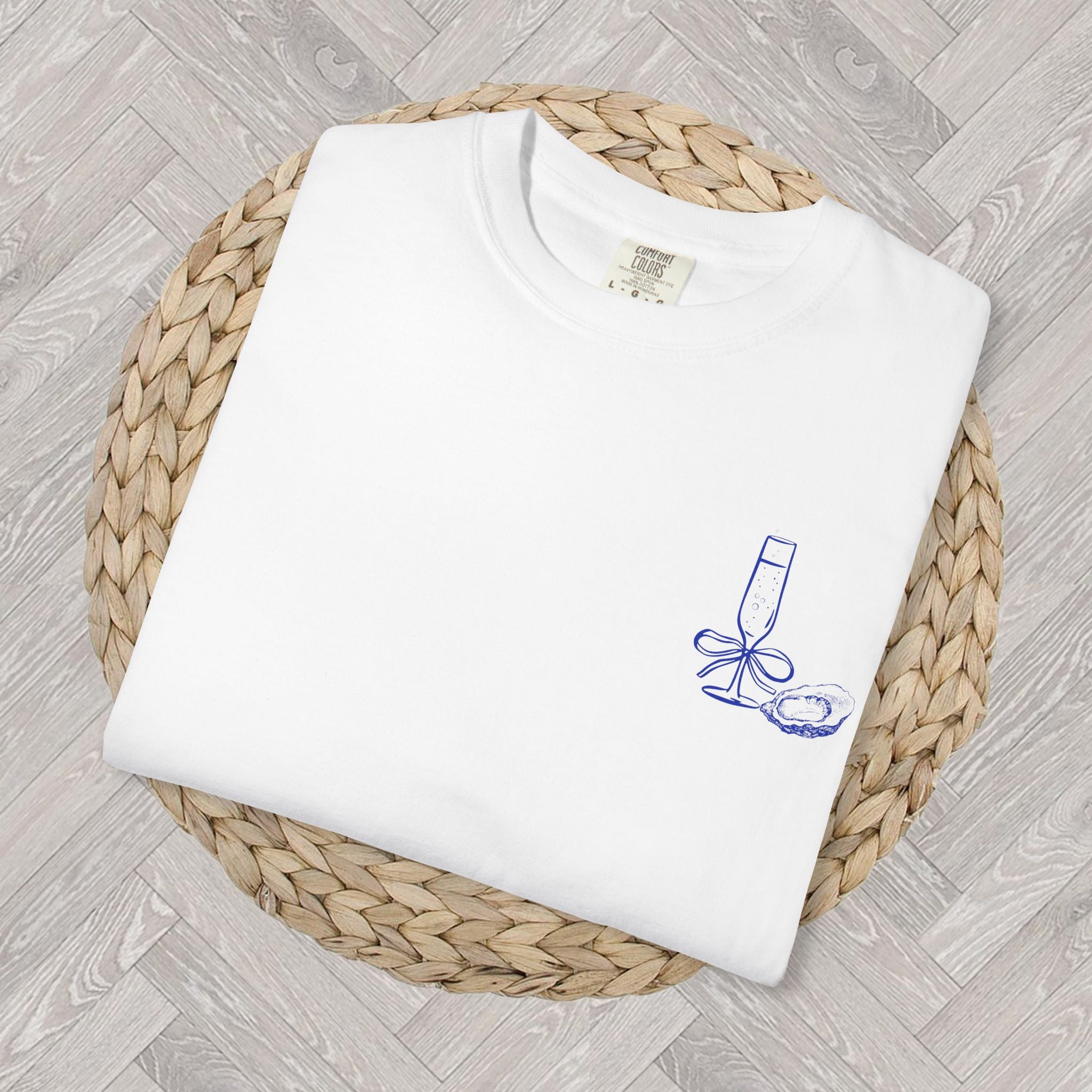 Front view of Oyster and Champagne graphic t-shirt styled with relaxed coastal aesthetic outfit