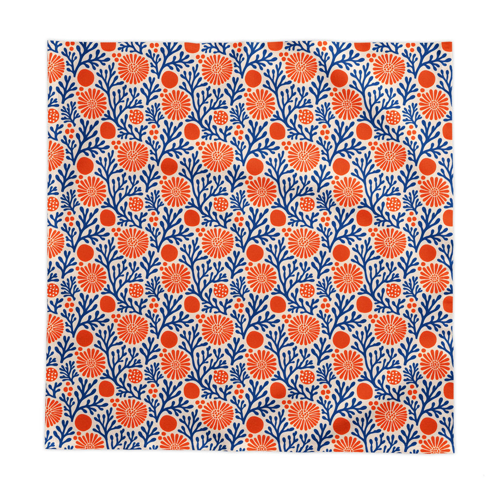 Modern Mediterranean dining décor featuring a blue coral reef cotton twill tablecloth with vibrant botanical motifs.