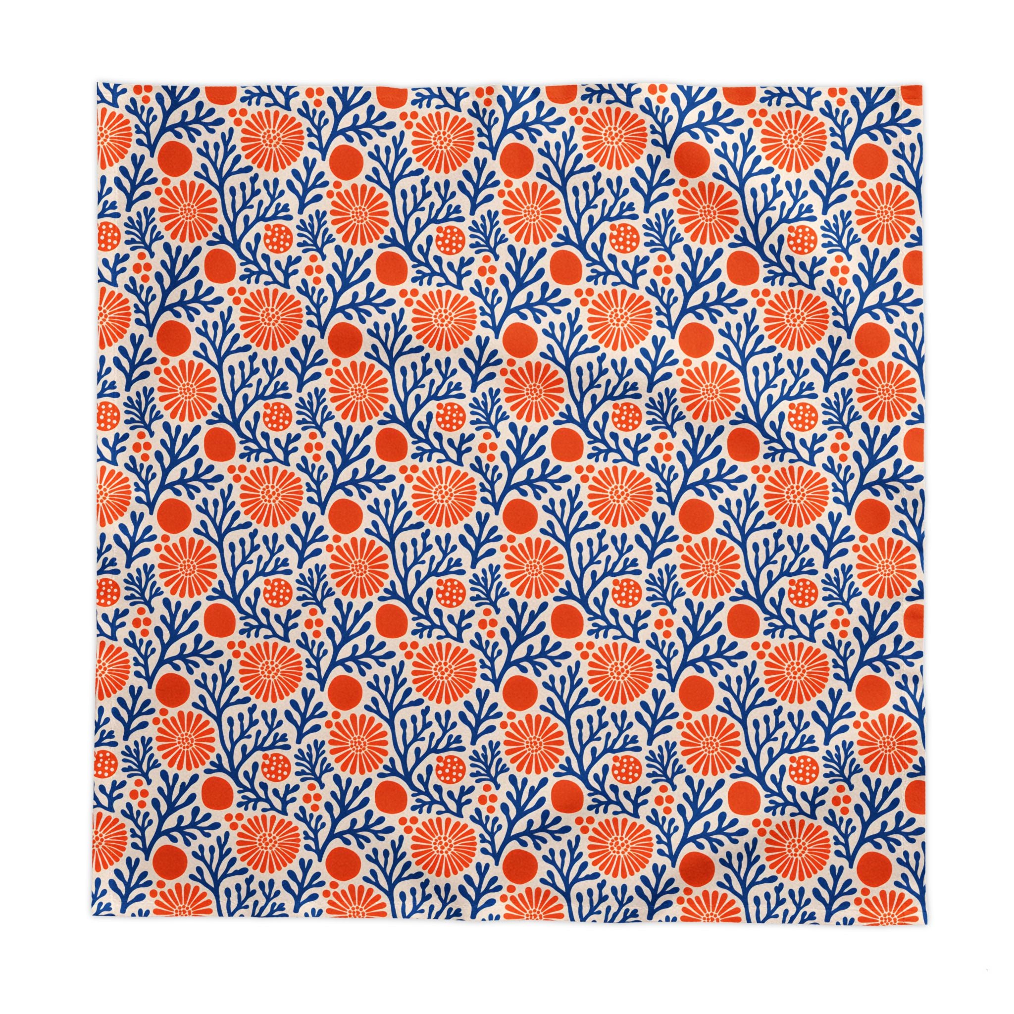 Modern Mediterranean dining décor featuring a blue coral reef cotton twill tablecloth with vibrant botanical motifs.
