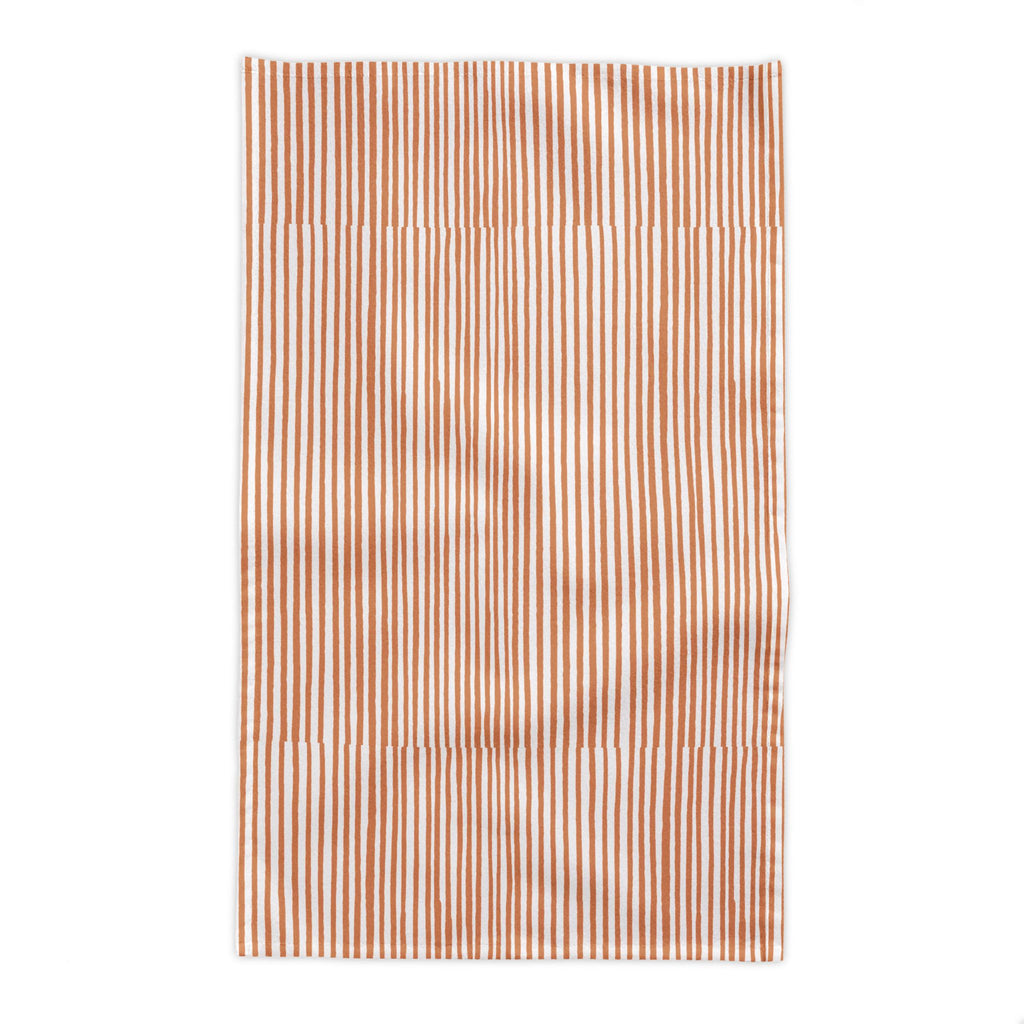 Soft terracotta hand-drawn stripe tablecloth in cream and warm rust tones, designed for modern Mediterranean dining and everyday entertaining.