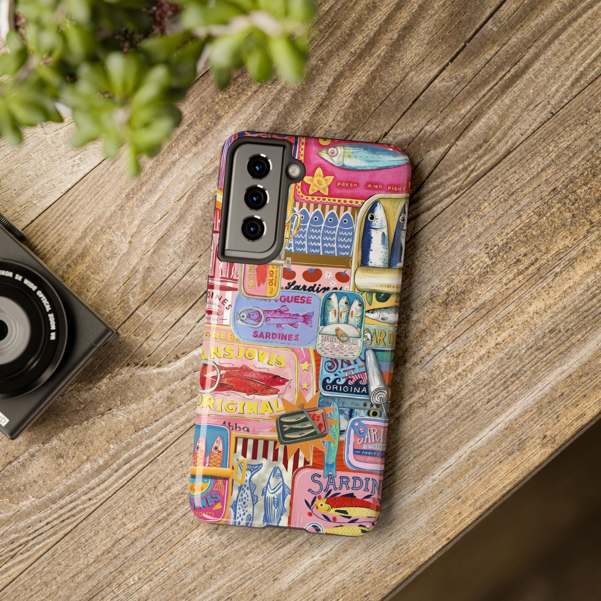 Artistic sardines phone cover with retro Mediterranean packaging illustrations in bold summer colours for iPhone and Samsung phones.