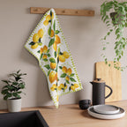 Mediterranean-inspired lemon tea towel displayed as kitchen decor with plants and wood accents