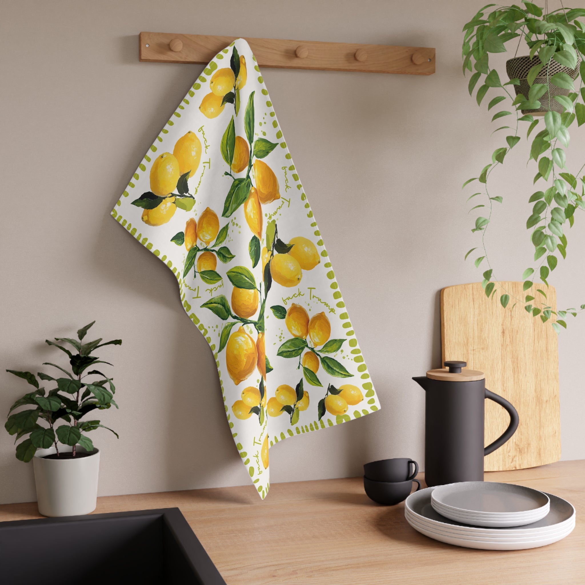 Mediterranean-inspired lemon tea towel displayed as kitchen decor with plants and wood accents