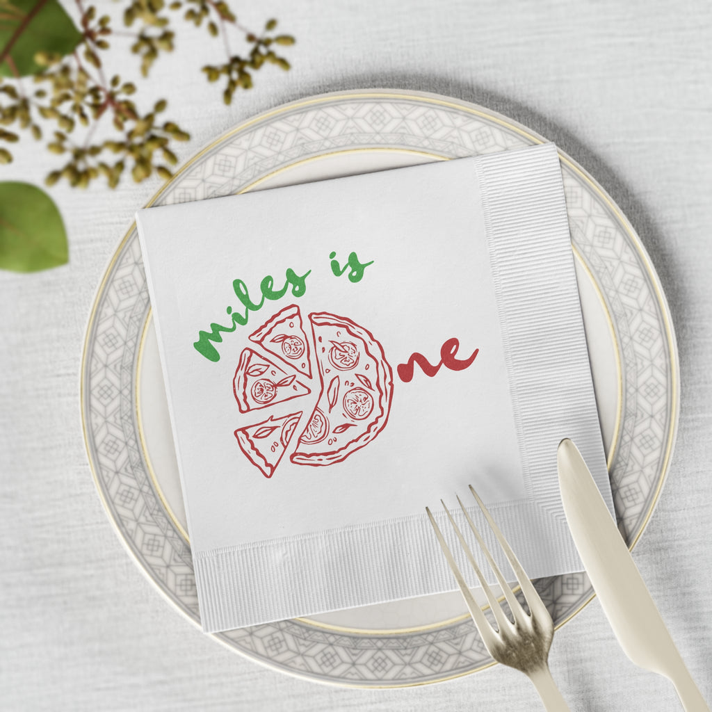 White three-ply personalized birthday napkin with a pizza-themed design for a child's first birthday party décor.