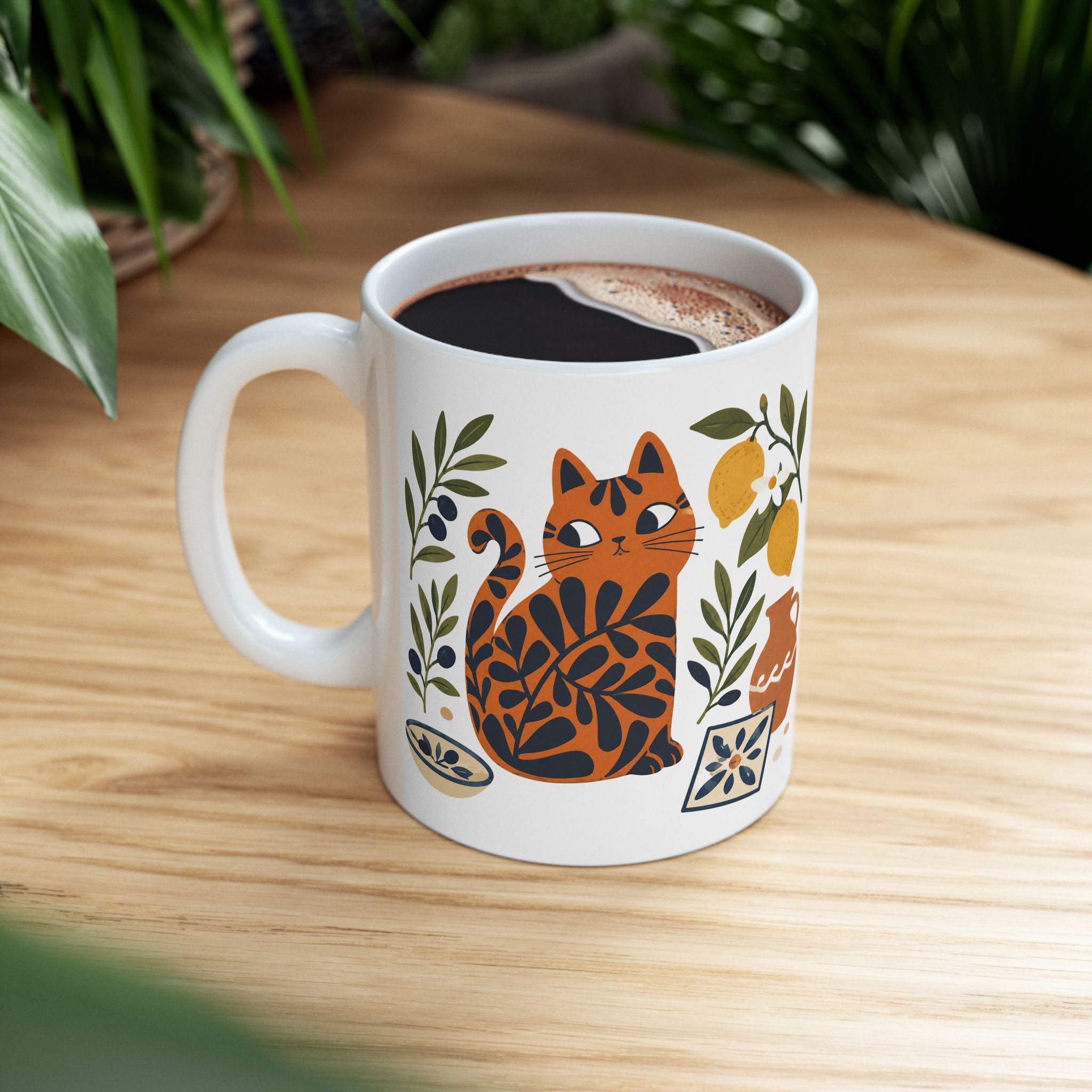 Ceramic tea mug featuring an artistic cat illustration with lemons, pottery, and Mediterranean tile motifs.