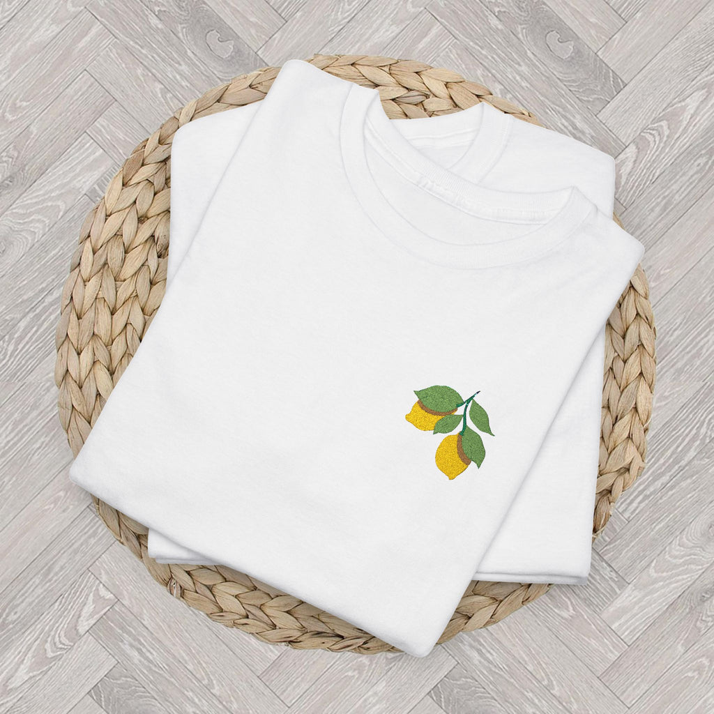 Folded lemon embroidered tee highlighting the detailed citrus and green leaf embroidery