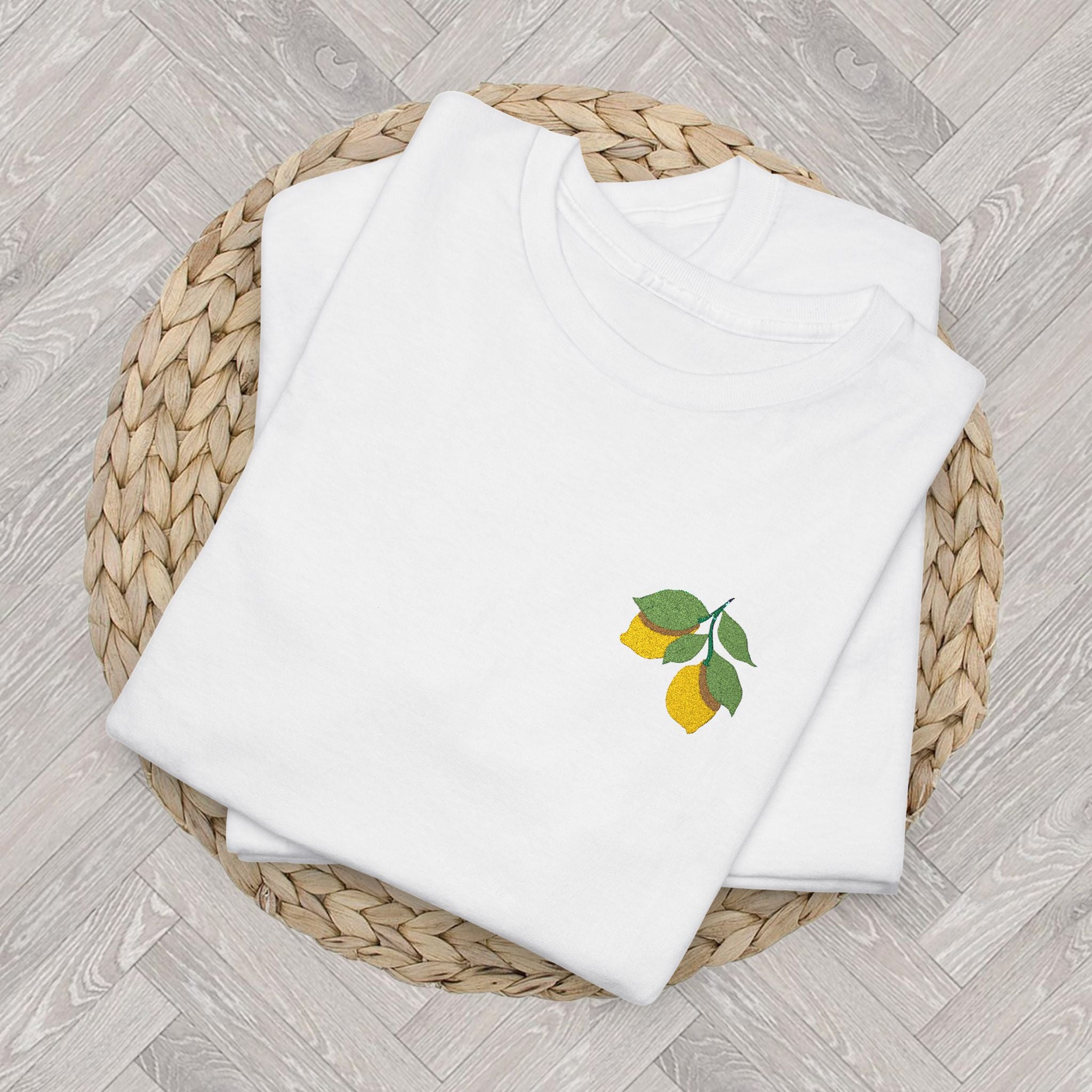 Folded lemon embroidered tee highlighting the detailed citrus and green leaf embroidery