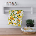 Watercolor lemon kitchen towel styled as decorative wall art in rustic kitchen setting