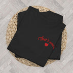 Flat lay of a personalised That's Amore wedding T-shirt with a cherubs design, customised with a name and wedding date.