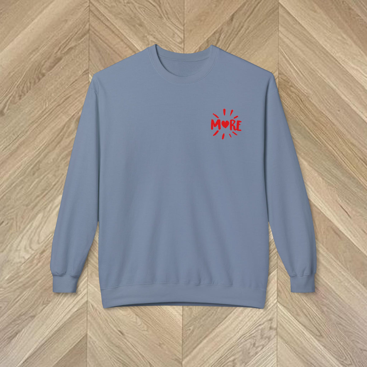 Close-up of the More Amore Por Favour sweatshirt showing playful heart artwork.